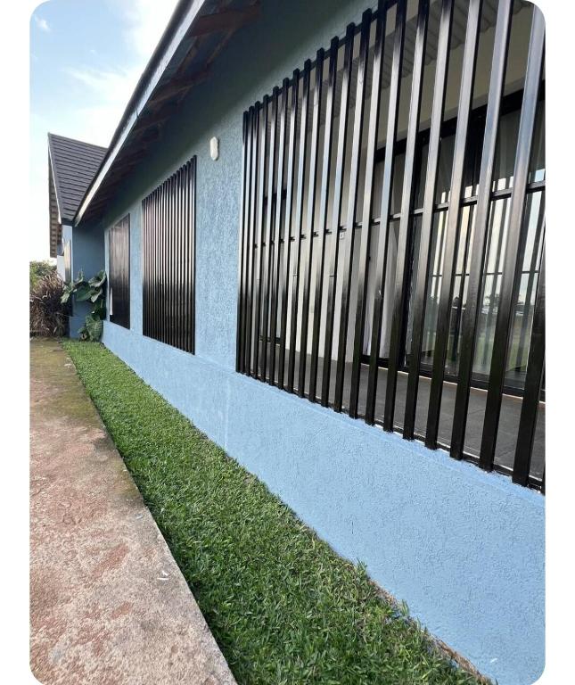 a fence on the side of a building with grass at Twenty ritz in Migori