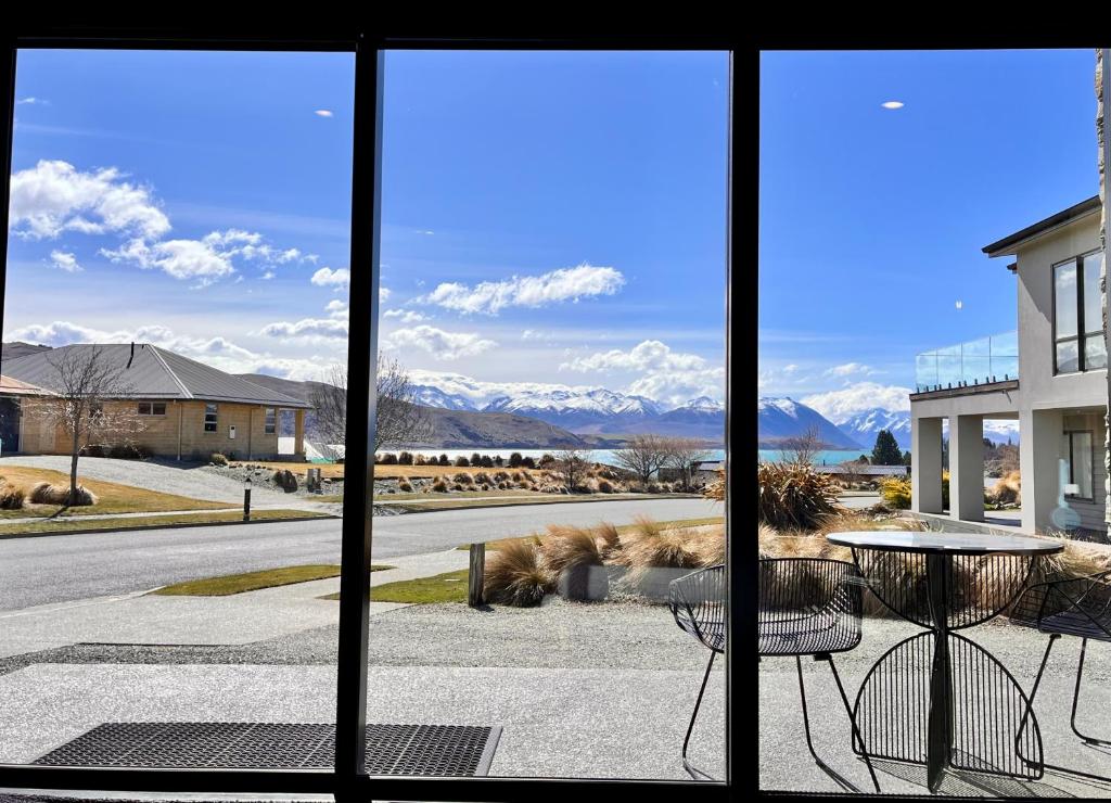 a view of the mountains from a window at Simply Stunning Stars A in Lake Tekapo