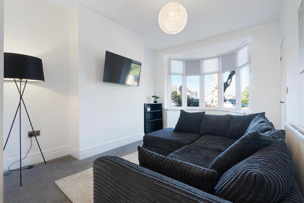 a living room with a couch and a tv at Spenny Homestay - Monthly & Weekly Stays in Byers Green