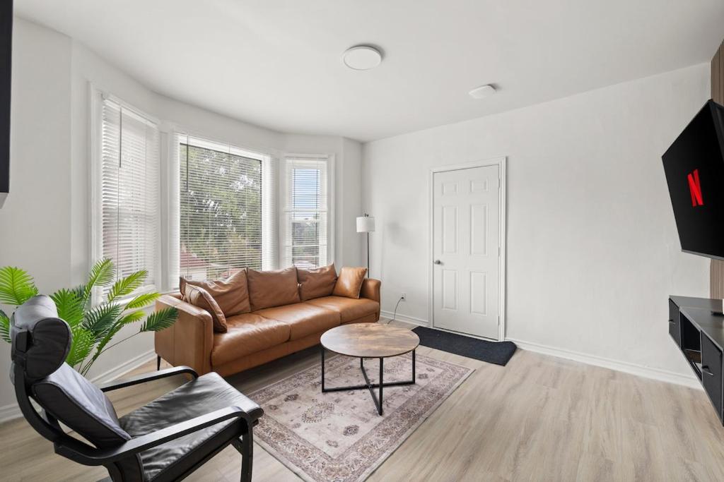 a living room with a couch and a table at New Build Sunny 2 Bedroom Unit in Windsor
