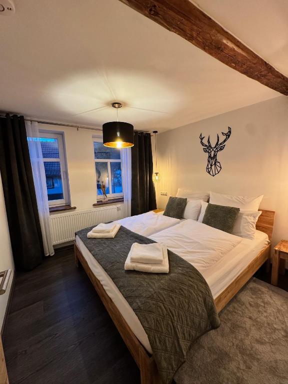 a bedroom with a large bed with two towels on it at MARKINA - Ferienwohnung - Kiliani I in Mühlhausen