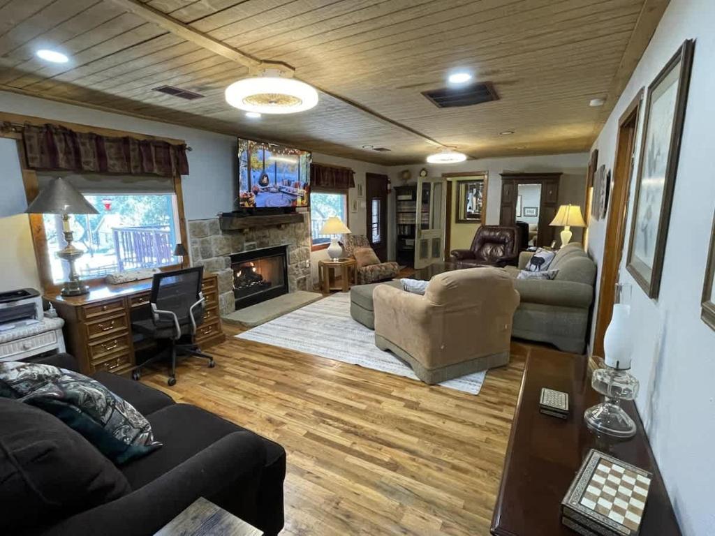 a living room with a couch and a fireplace at Midtown Meadow Cabin in Ruidoso