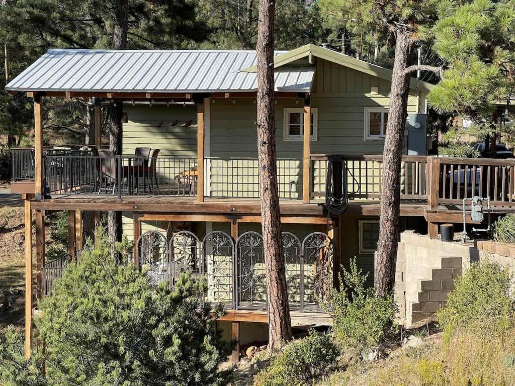 a house with a large deck with a porch at Montana Vista in Ponderosa Heights