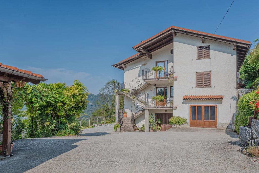 a large white house with a driveway at Apartment Marta Slovenia Natures - Happy Rentals in Levpa