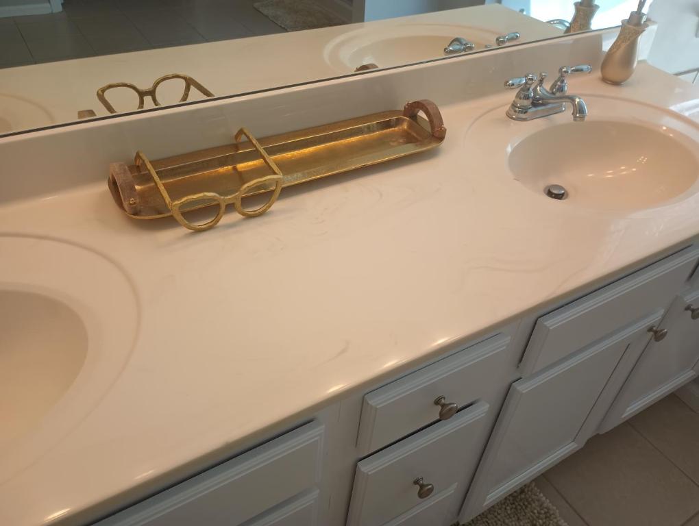 a bathroom sink with a gold towel bar on it at The Serene in Between in Snellville