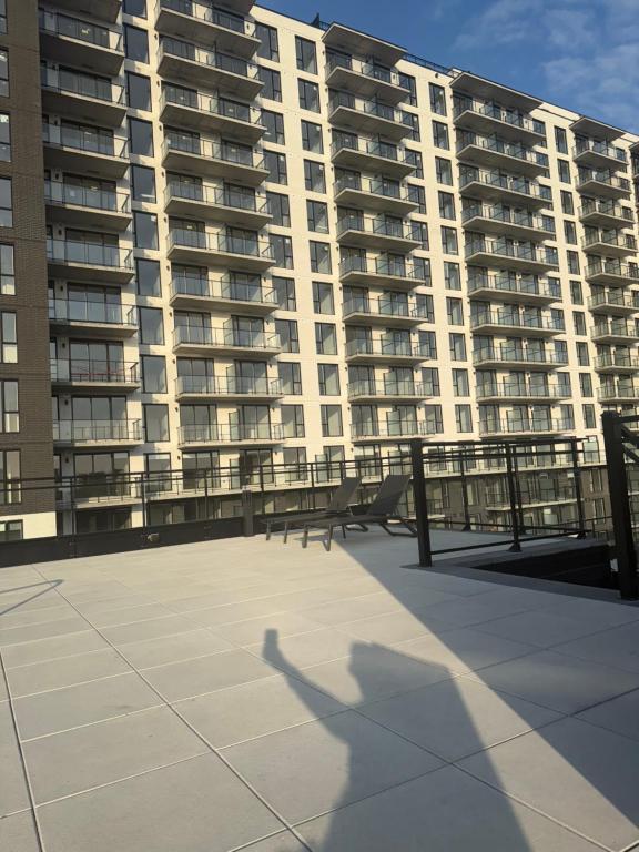 a shadow of a person standing in front of a large building at Griffintown luxury 1 open bedroom apartment in Montréal
