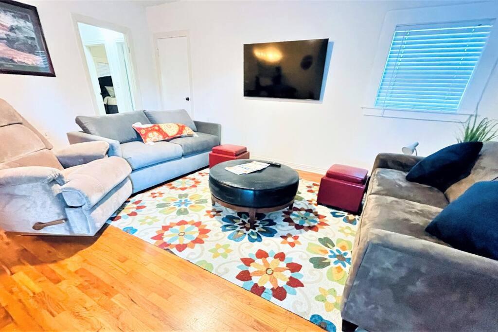 a living room with a couch and a coffee table at The great retreat - 1 mile from the University in Fayetteville