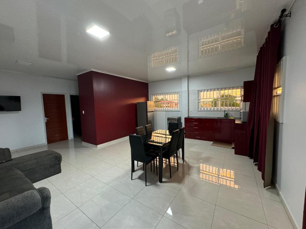 a living room with a table and chairs at RJ Appartement in Paramaribo