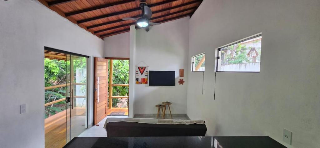 a living room with white walls and a ceiling at Sincorá Guesthouse in Lençóis