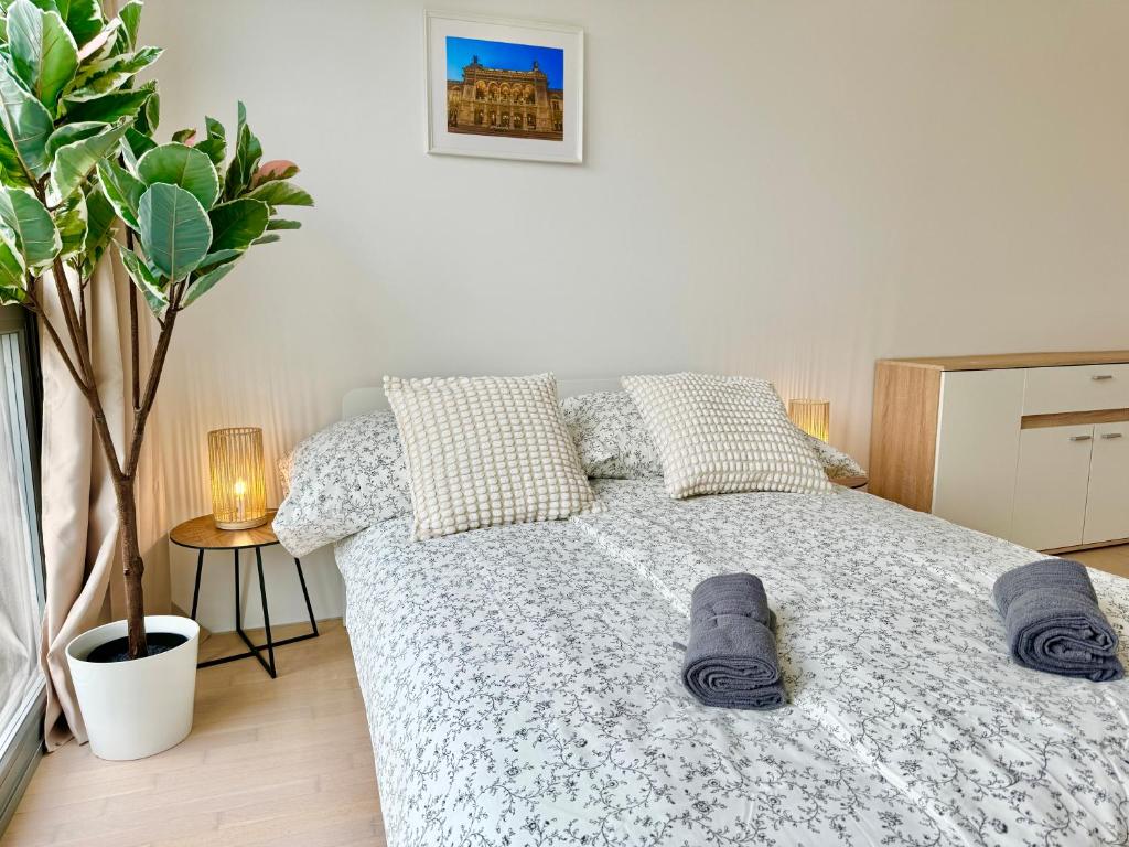 a bedroom with a bed with two slippers on it at Modern Stylish Luxury Apartment with Parking in Vienna