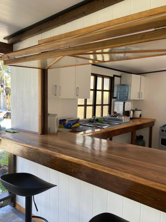 a large kitchen with a wooden counter top at Nhn Lodge in Avatoru