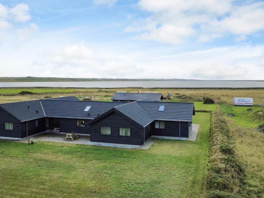 an aerial view of a house in a field at Luxury Retreat with Pool - By Traum Ferienwohnungen in Harboør