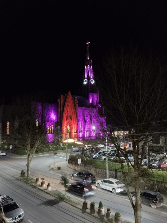 a building with purple lights on it at night at Apartamento Bolognese in Canela