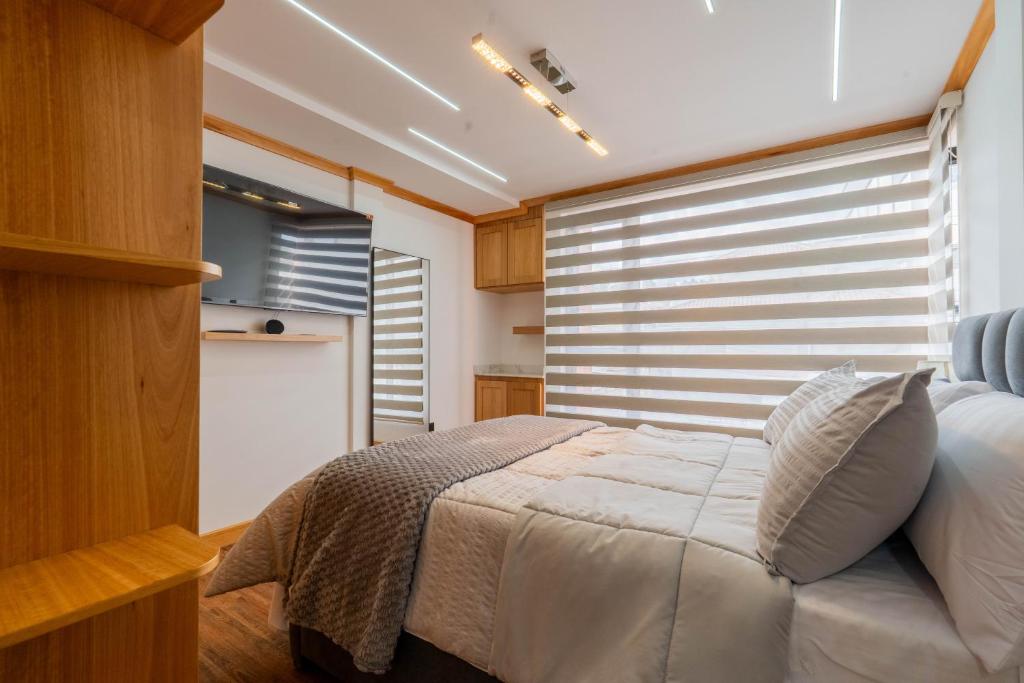 En eller flere senge i et værelse på Moderna Casa Cuenca