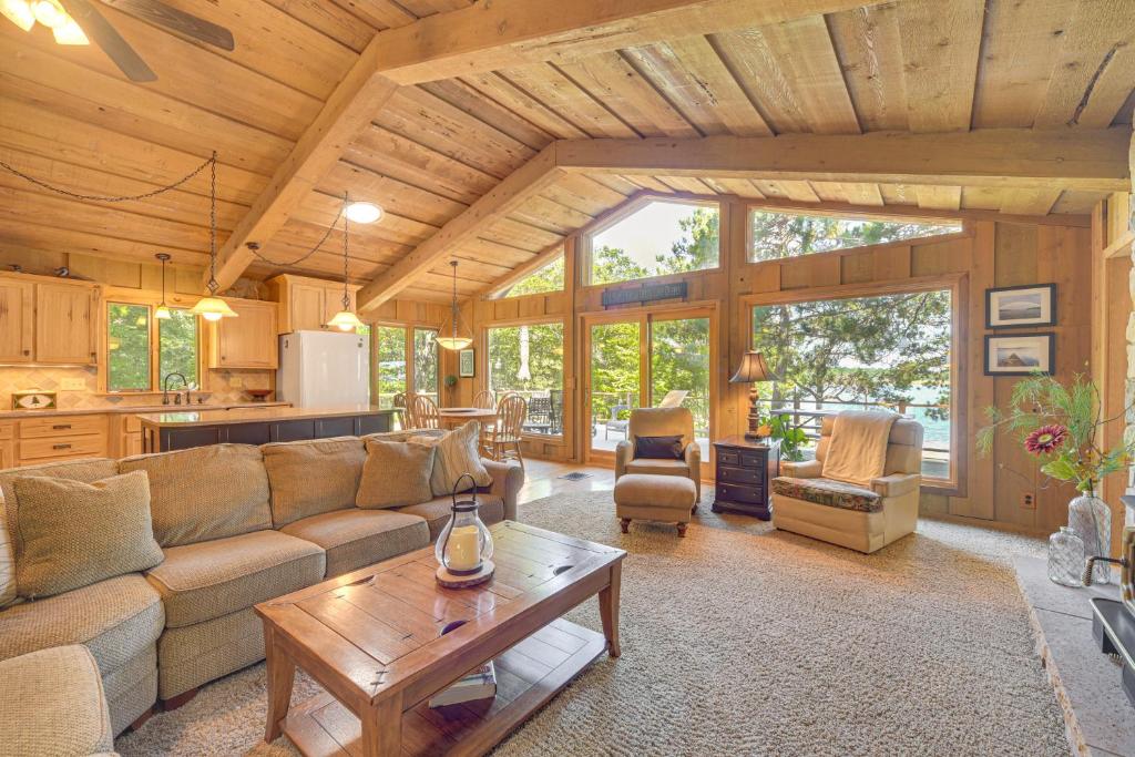 a living room with a couch and a table at Waterfront Escape on Big Sand Lake with Private Dock in Minong