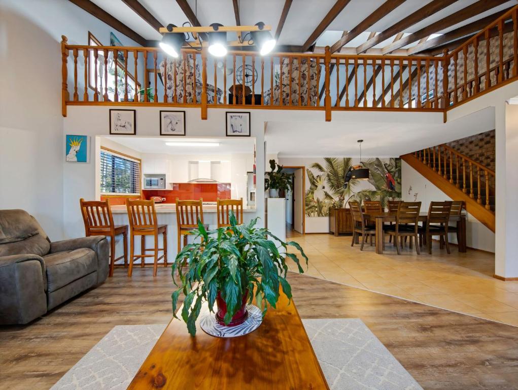 a living room with a couch and a table at Sunshine Bay Serenity Beachside Escape in Denhams Beach