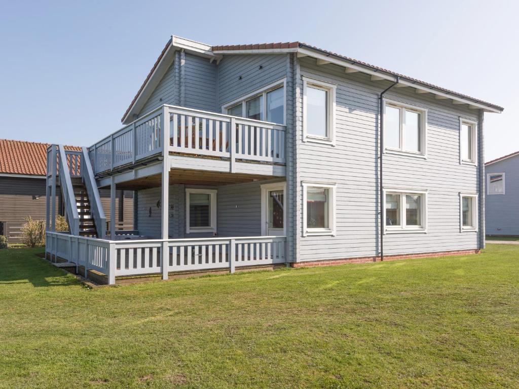 a large house with a balcony and a yard at Broad Reach - 28121 in Fritton Norfolk