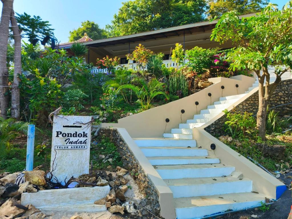 a set of stairs leading up to a house at Pondok Indah Teluk Asmara in Roworante
