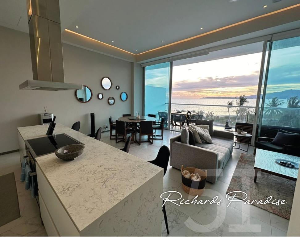 a living room with a view of the ocean at Marítima Playa Flamingos Renting 5i Richards in Bucerías