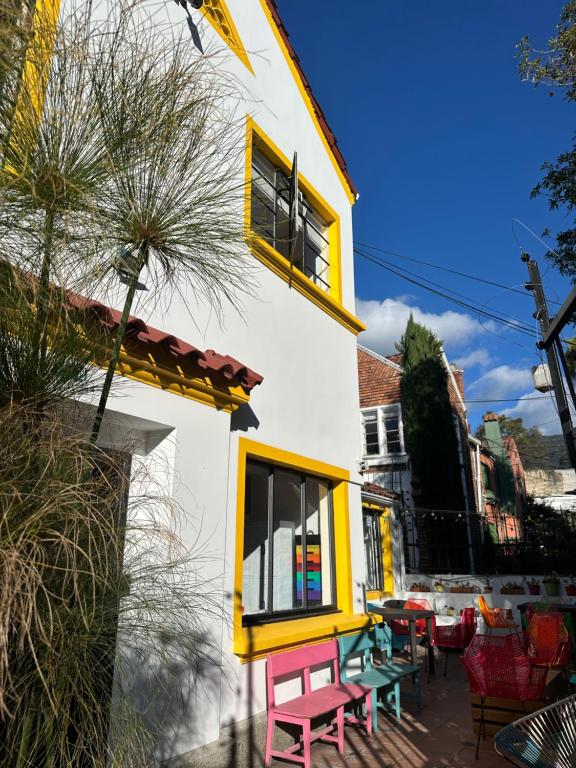 a house with a table and chairs in front of it at Vecinos by La Palmera in Bogotá