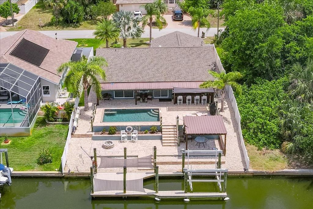 an aerial view of a house with a swimming pool at Waterfront Retreat with Pool Tiki Bar & Boat Dock in Bon Terra