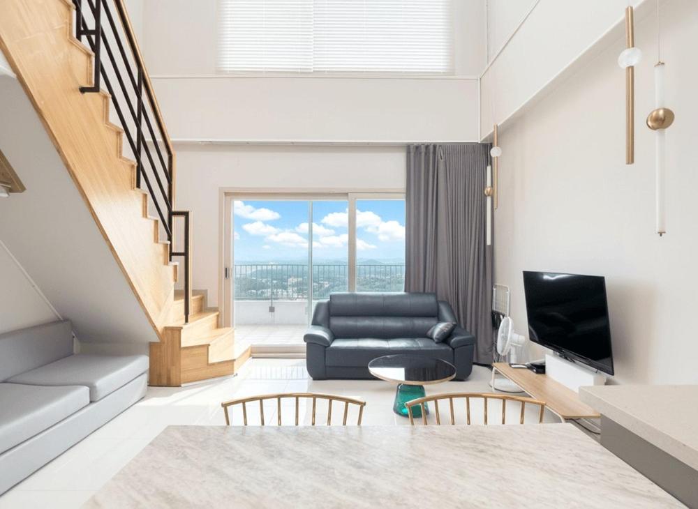 a living room with a couch and a television at Sokcho Whalejib The Blue Terra Ocean Stay in Puwŏl-li