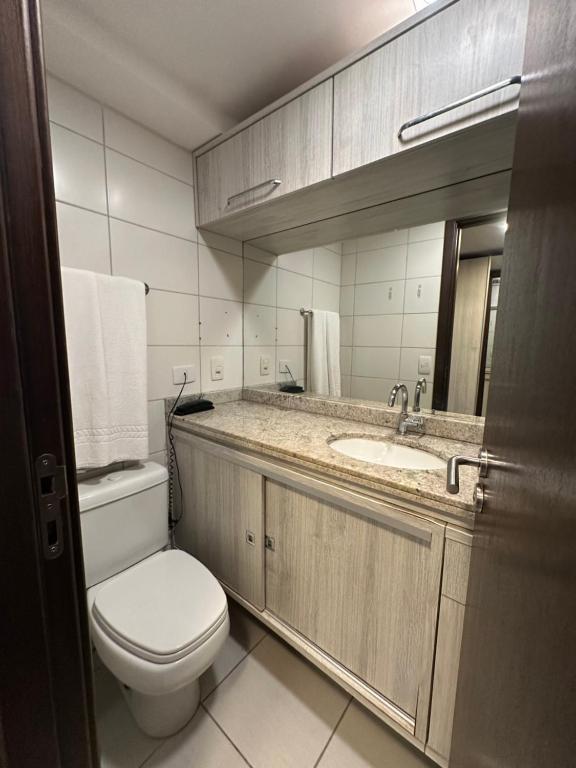 a bathroom with a toilet and a sink at Seaside Refuge in Recife