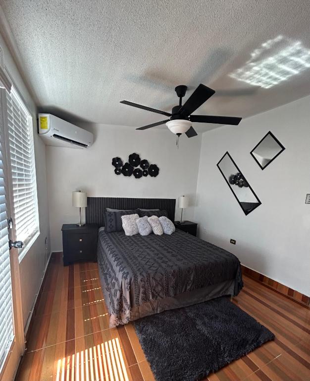 a bedroom with a bed and a ceiling fan at Estudio práctico y confortable en segundo piso in Senecú