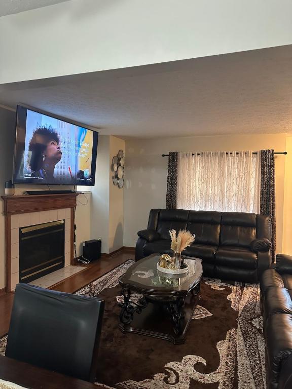 a living room with a couch and a flat screen tv at quiet and comfortable in Cleveland
