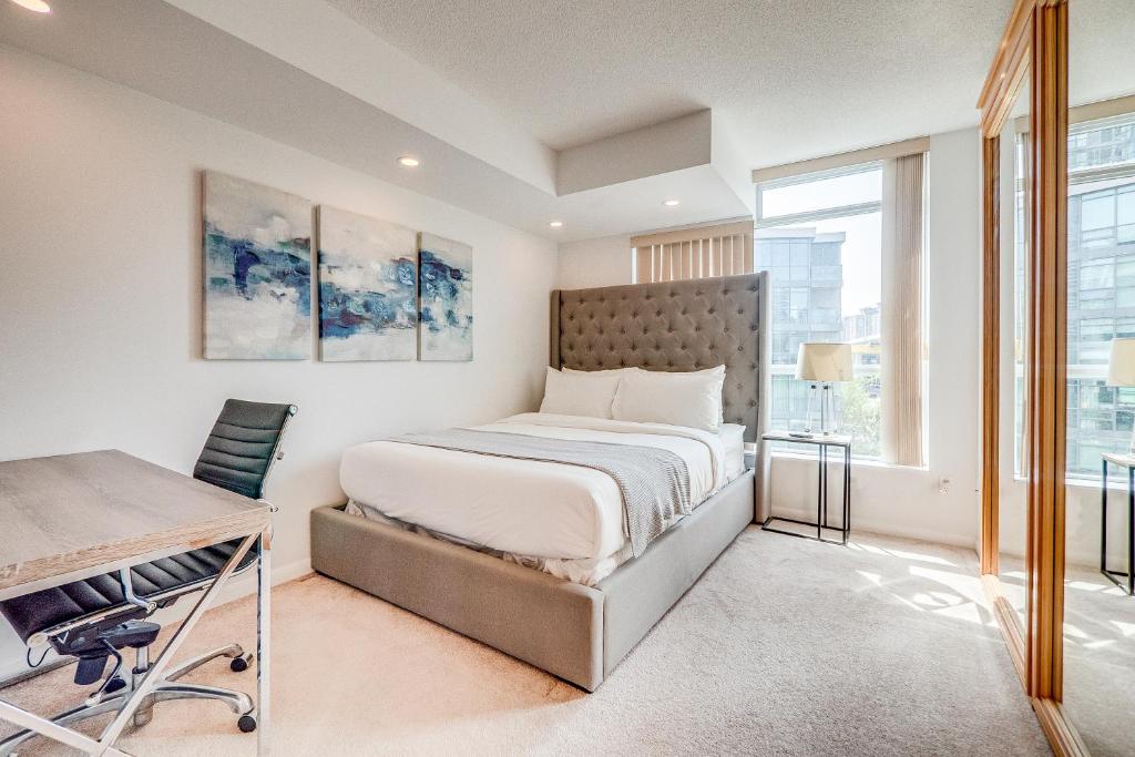 a bedroom with a bed and a desk at 2BR Condo - Free Parking - Park & City View in Toronto