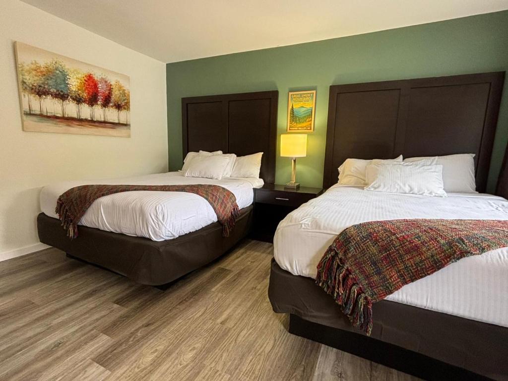 a hotel room with two beds and a painting on the wall at Castlewood Inn in Maggie Valley