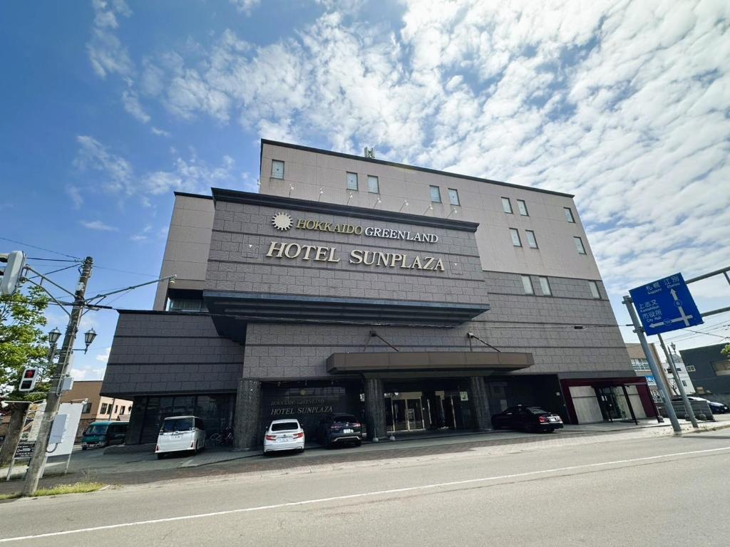 a hotel with cars parked in front of it at Hokkaido Greenland Hotel Sunplaza in Iwamizawa