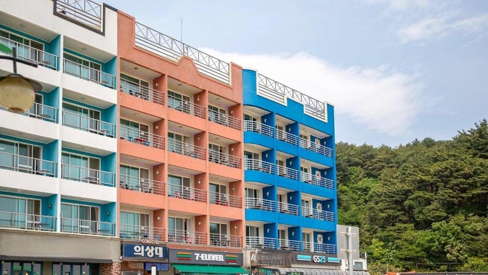 a tall building with balconies on the side of it at Yangyang Naksaneuisangdae Pension in Chosan-ni