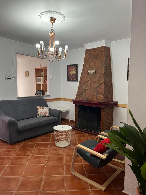 a living room with a couch and a fireplace at El Rinconcito de Nadia in Benaocaz