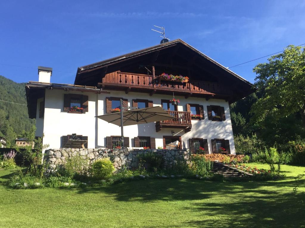 a large white house with a balcony at B&B Rossodisera in Domegge di Cadore