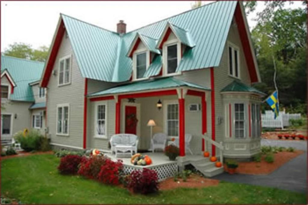 a red and white house with a green roof at Red Elephant Inn Bed and Breakfast in North Conway