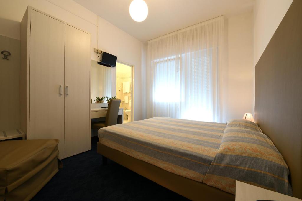 Postel nebo postele na pokoji v ubytování Hotel Savoia