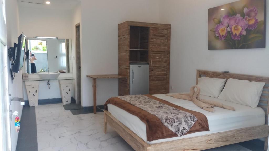 Ένα ή περισσότερα κρεβάτια σε δωμάτιο στο Orchid Homestay Jimbaran