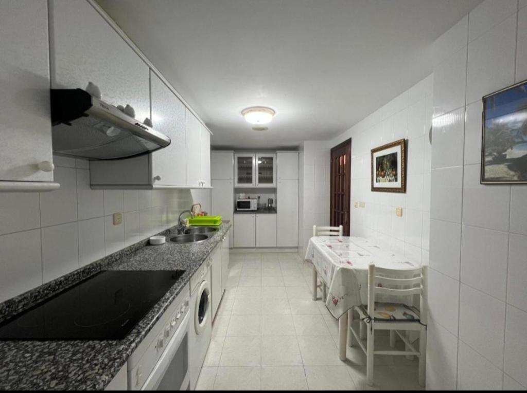 a kitchen with a sink and a counter top at Habitación en A Coruña con baño privado in Visma