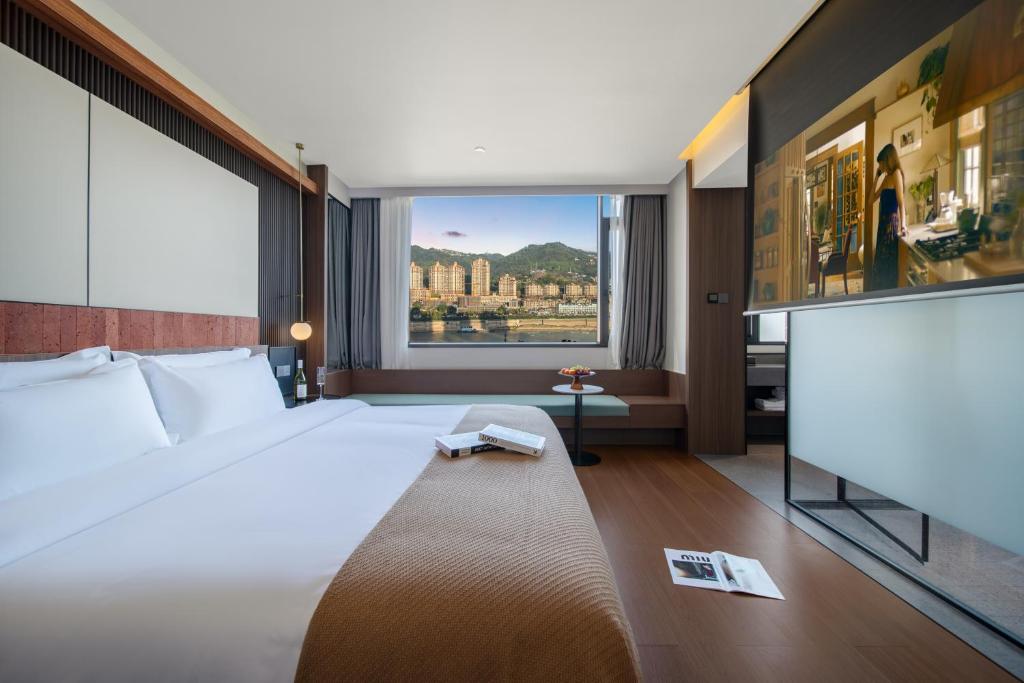 Postel nebo postele na pokoji v ubytování Chongqing Shanlai Jiangwang Jiangwang Hotel
