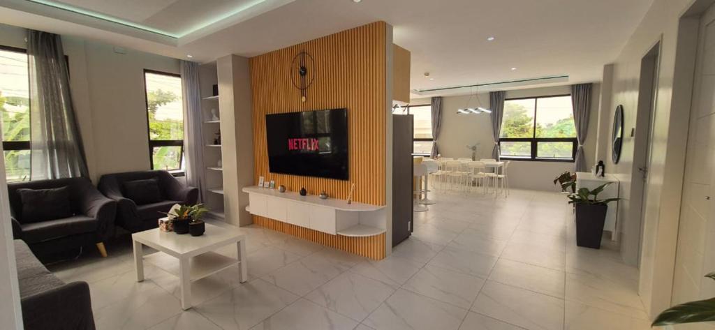 a living room with a tv on a wall at ICB Suites in Tagbilaran City