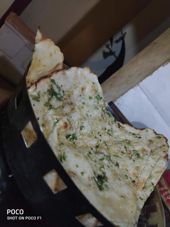 a slice of cheese pizza in a box at Hotel A1 family restaurant Bar & Lodge in Birvādi