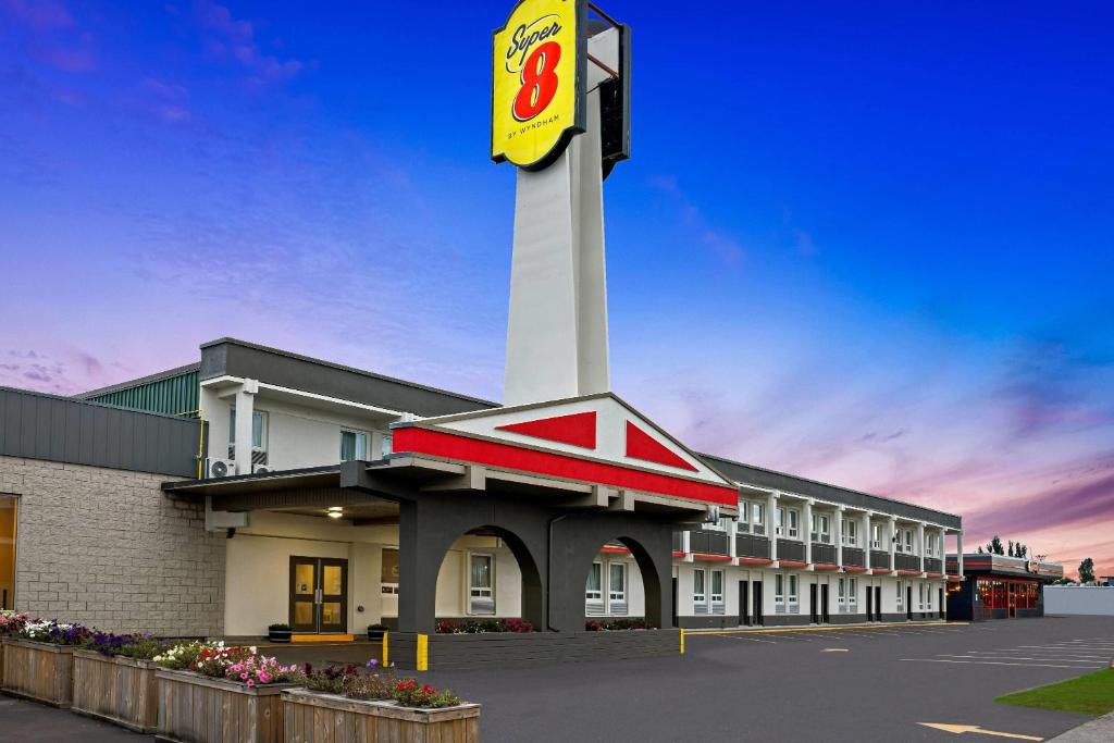 a building with a clock tower in a parking lot at Super 8 by Wyndham Thunder Bay in Thunder Bay