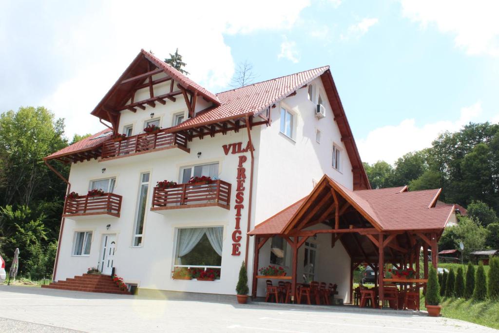 ein großes weißes Gebäude mit rotem Dach in der Unterkunft Villa Prestige in Sovata