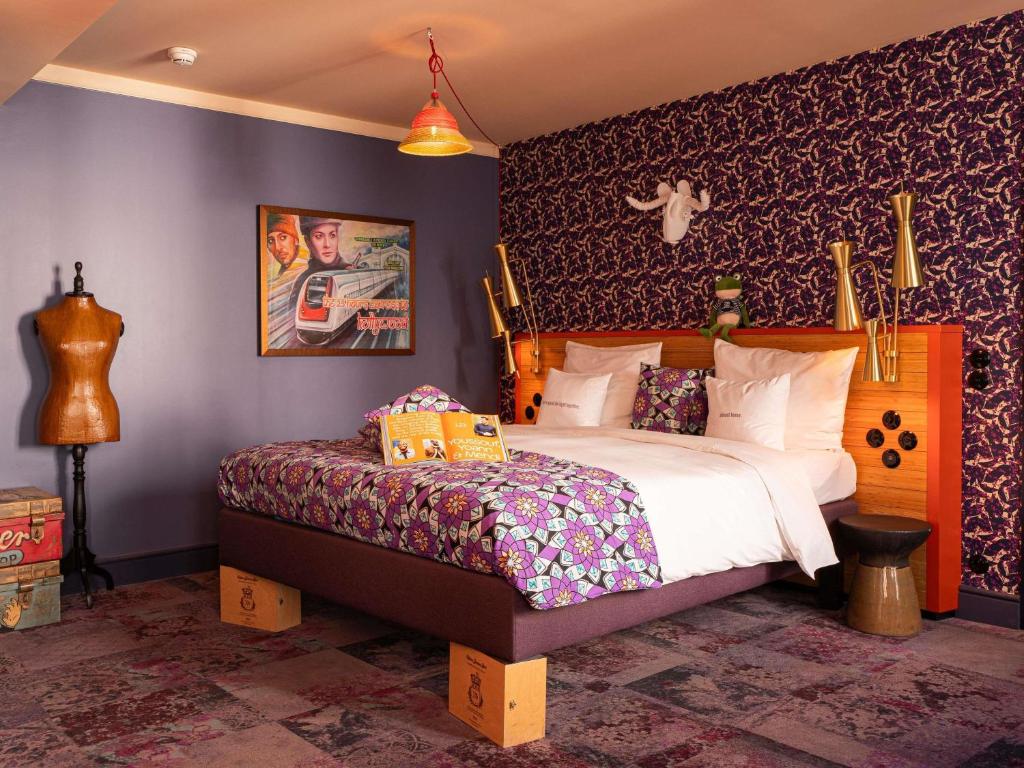 a bedroom with a bed and a wall at 25hours Hotel Terminus Nord in Paris