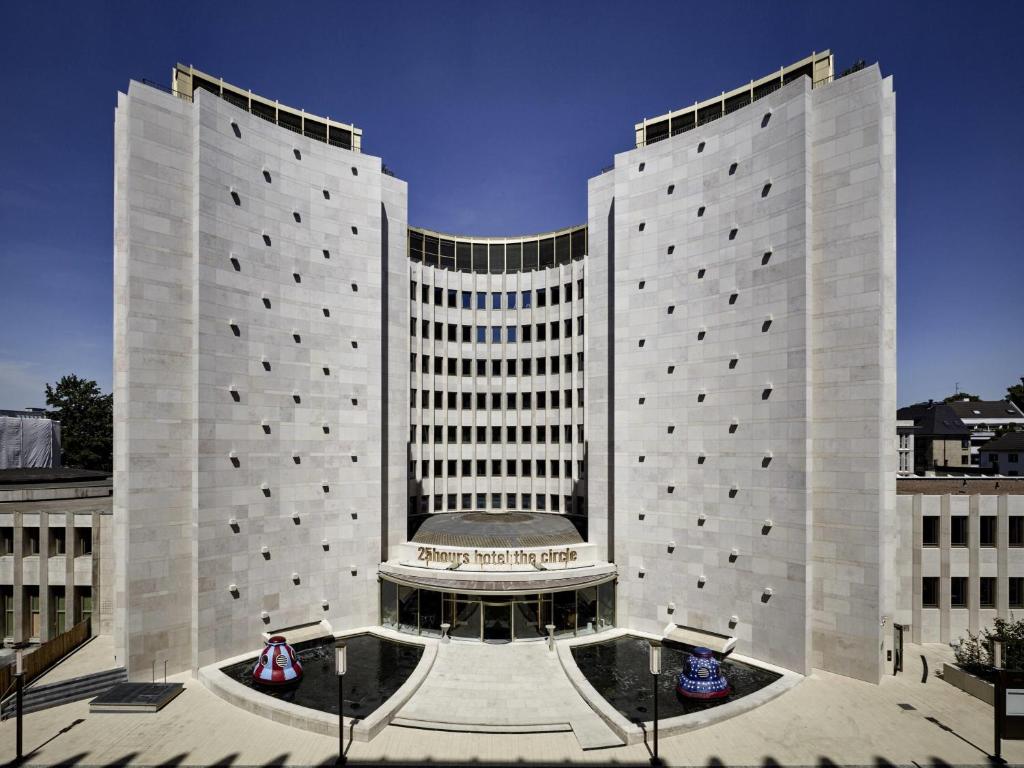 a large building with two tall buildings at 25hours Hotel The Circle in Cologne