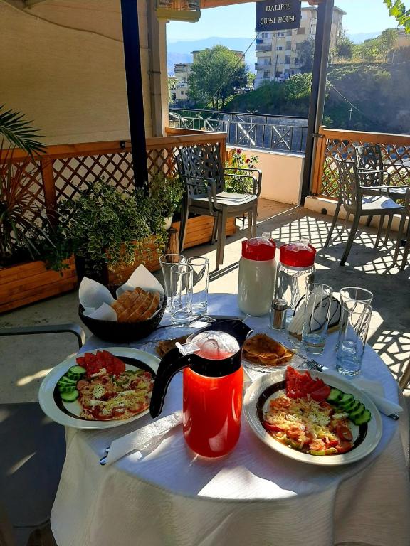 a table with two plates of food on it at Old Bridge Guest House in Gjirokastër