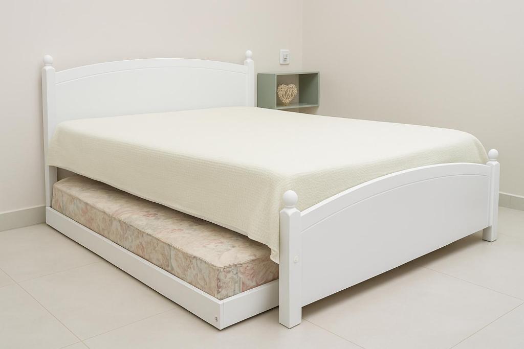 En eller flere senge i et værelse på Fazenda Grand-Place