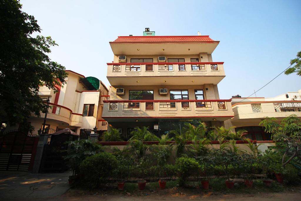 a tall building with balconies and plants in front of it at Hotel O The Vagmi - Paradise in Gurgaon