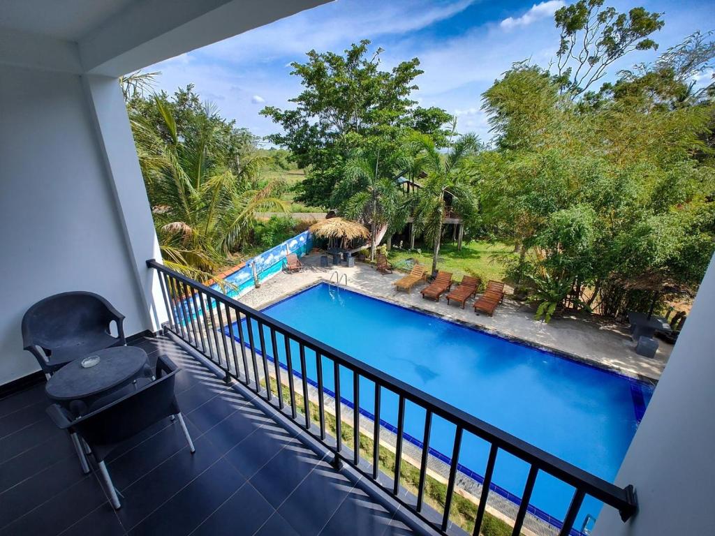 a view from the balcony of a resort with a swimming pool at Amelia Resort in Sigiriya
